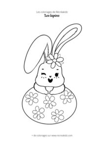 Coloriage de lapin avec oeuf et fleurs